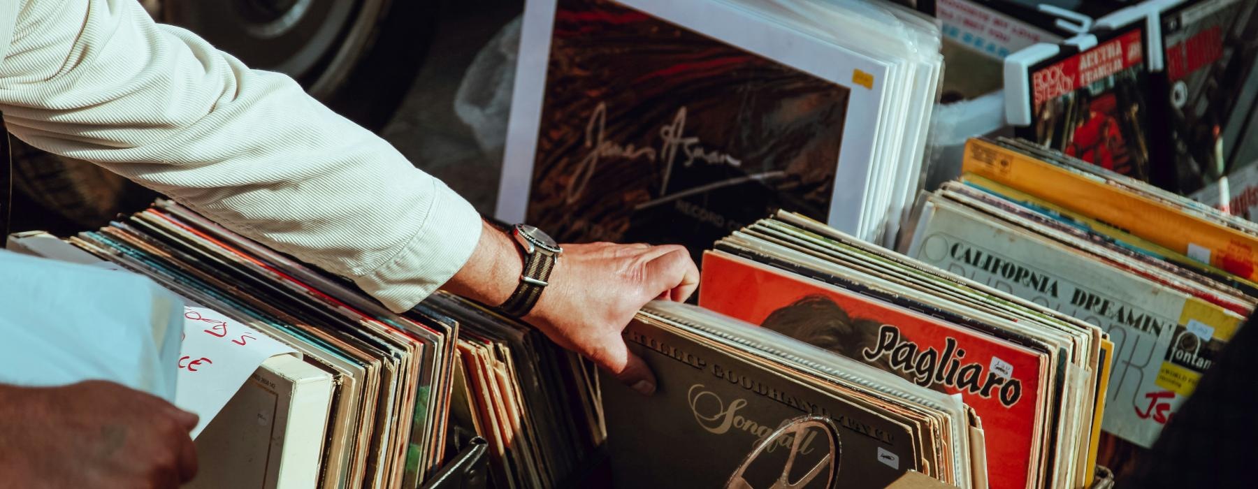 a person reaching through vinyls