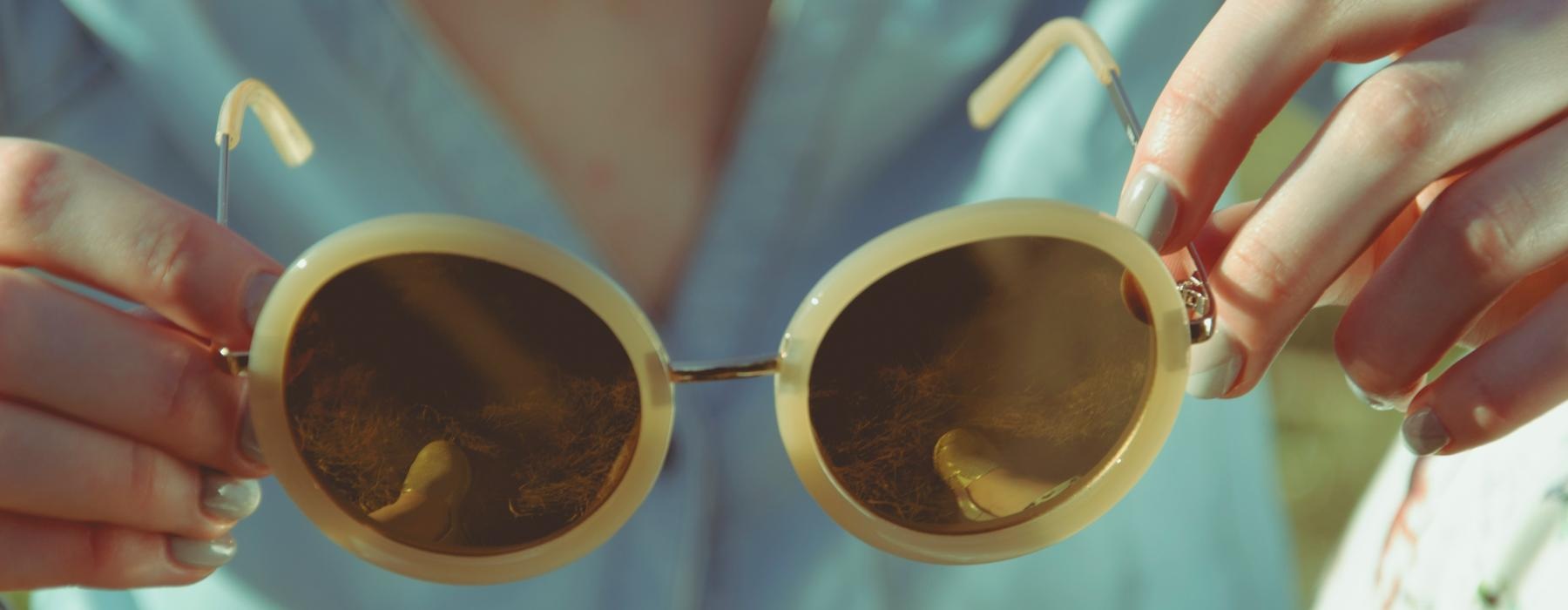 a person holding a pair of glasses